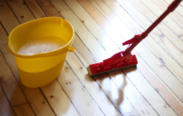 Cleaning wooden floor with a mop